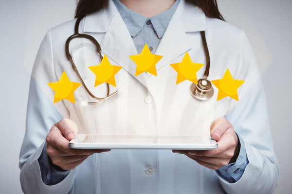 Doctor holding tablet with 5 stars